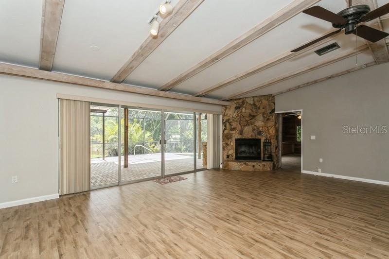 Living room views of fireplace and pool
