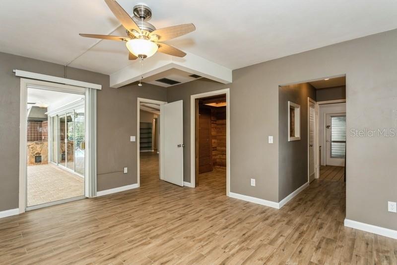 Primary bedroom leading to bathroom and laundry hallway