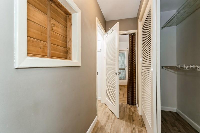 Hallway to bathroom with more closets