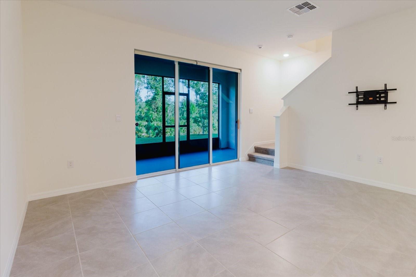 Great Room with large slider and stairs to go up