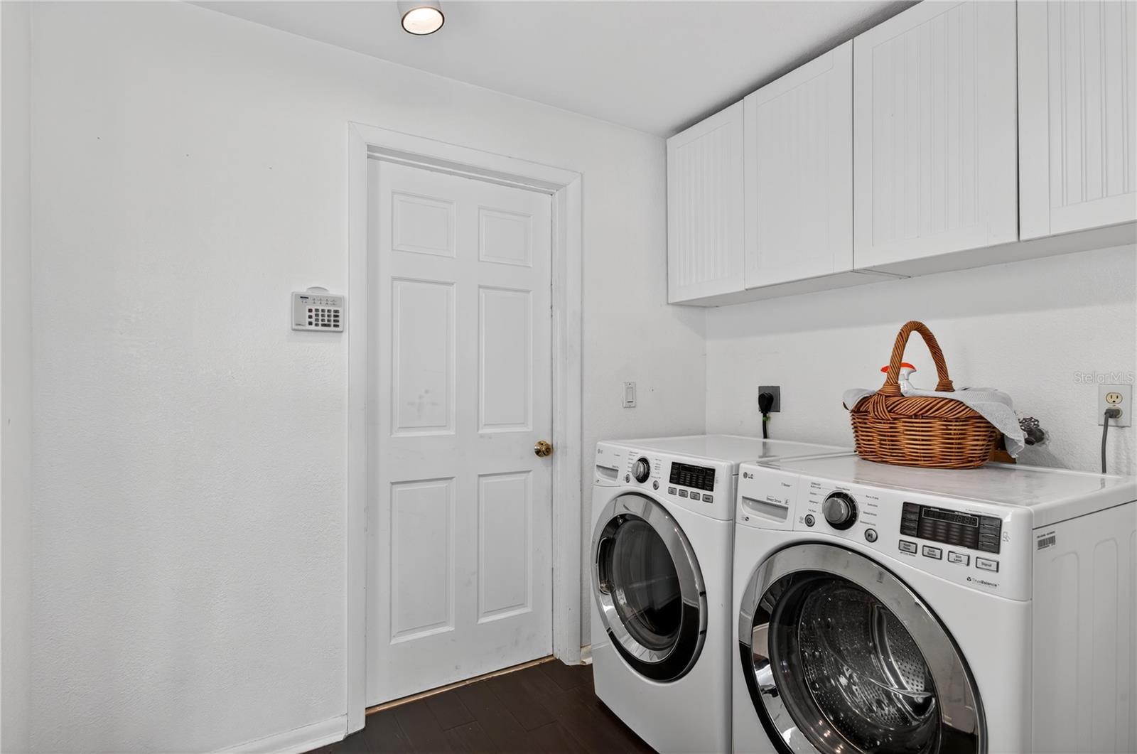 Laundry area with built in cabinets