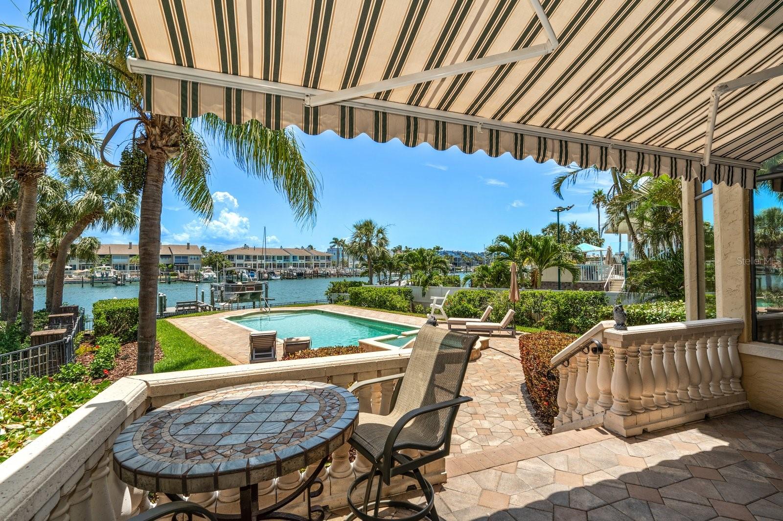 Retractable awning over the balcony overlooking pool