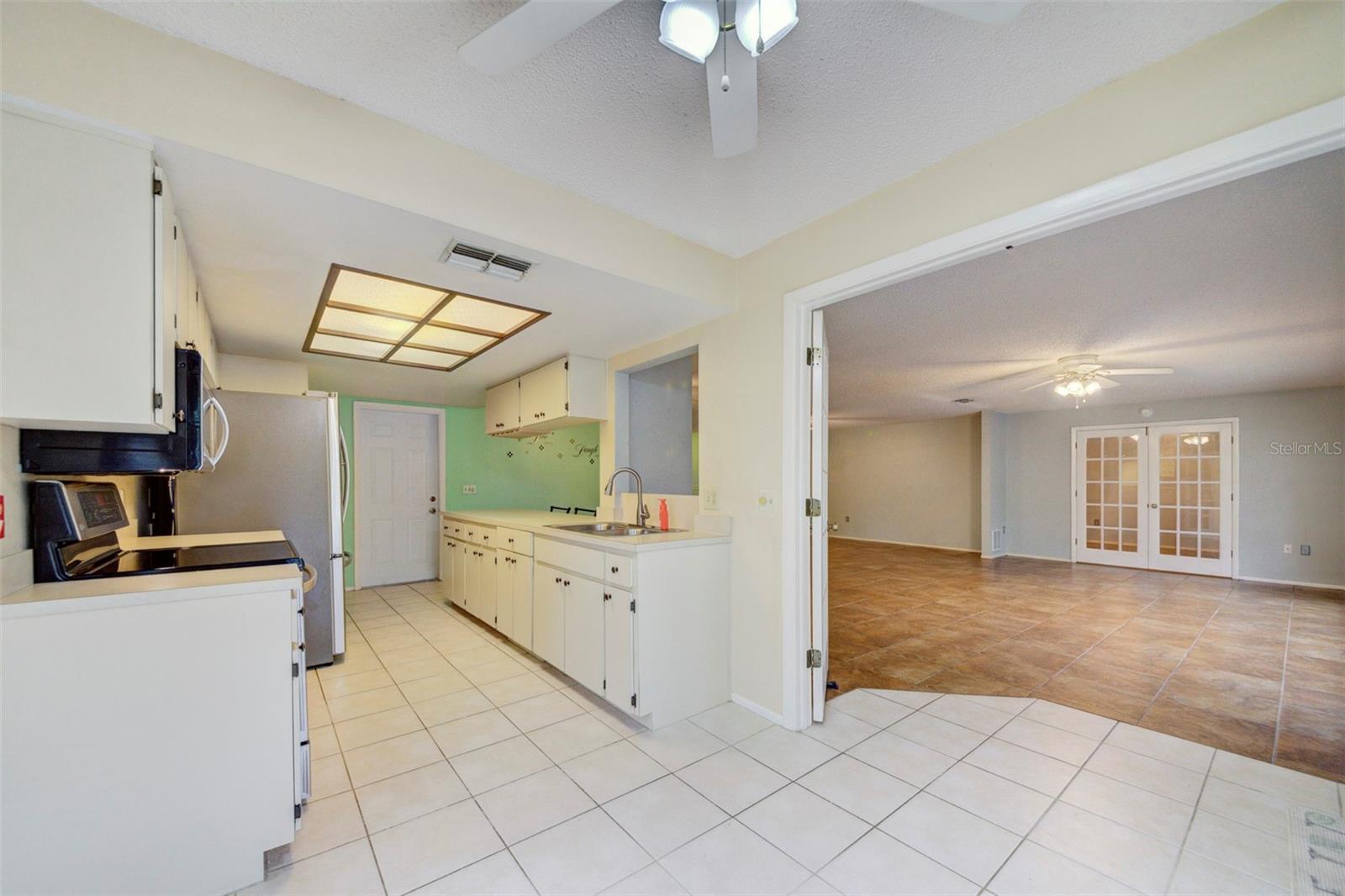 Kitchen from eat-in area.  Open French doors into living space.