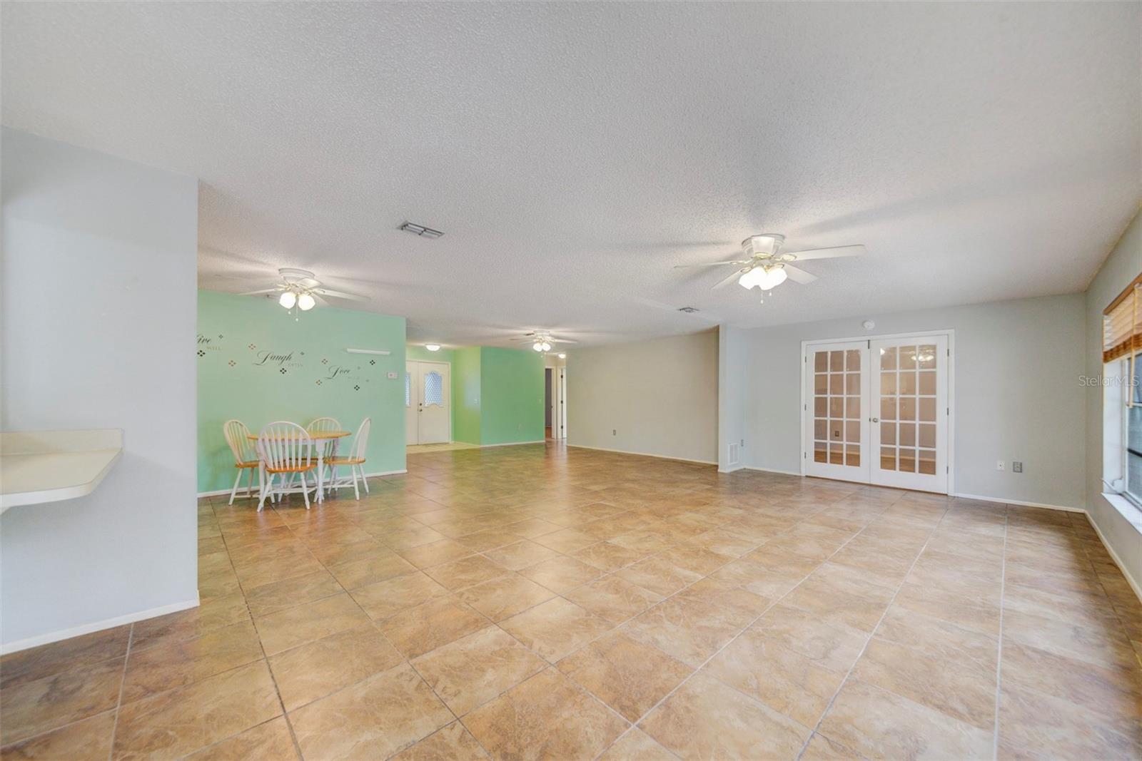 Open living space, with French doors to back bedroom