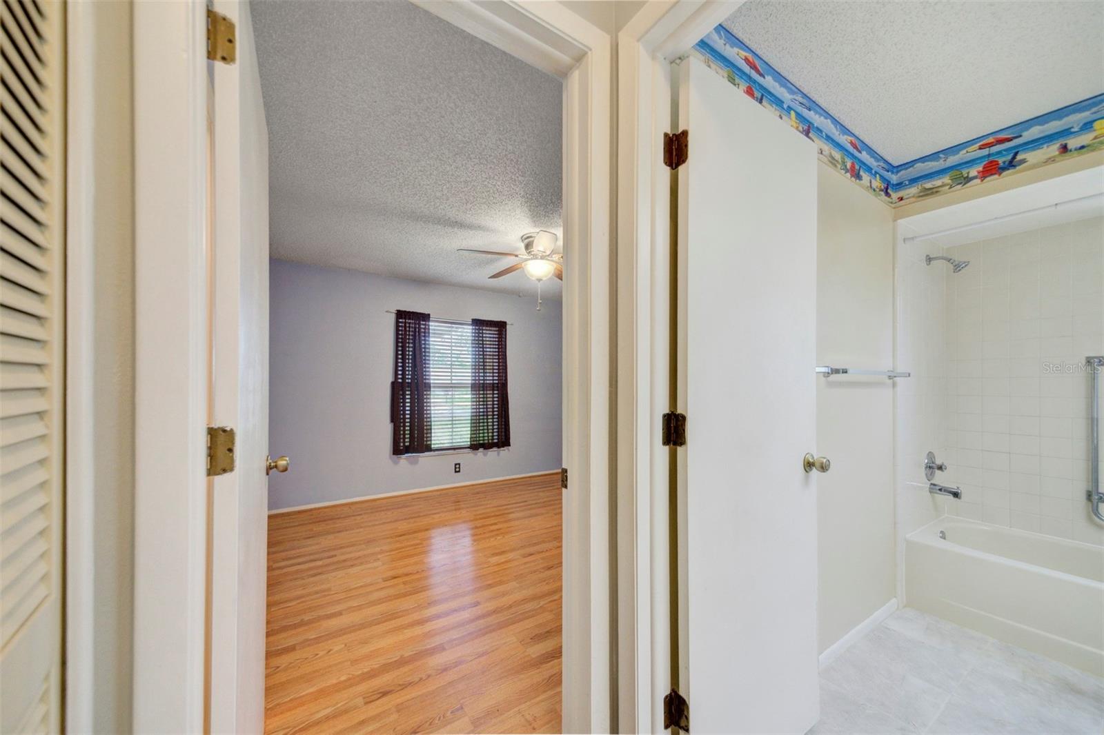 hallway into front bedroom and bath