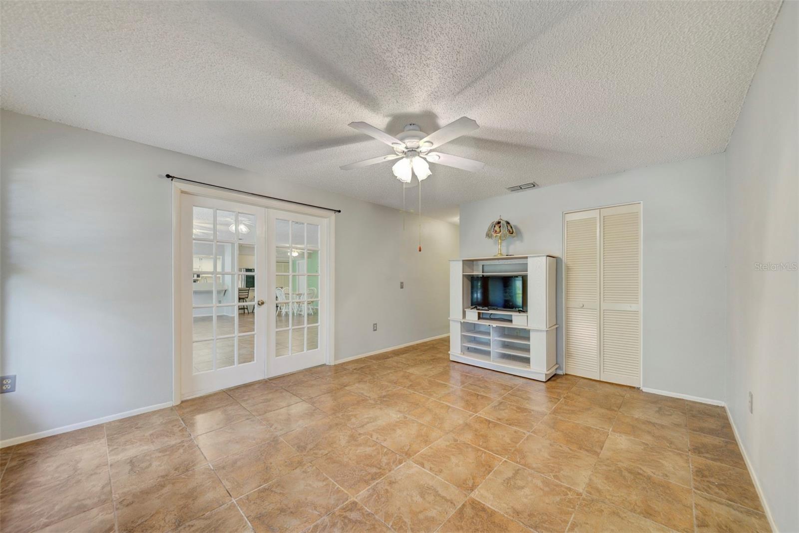 Back bedroom, with TV and wall unit