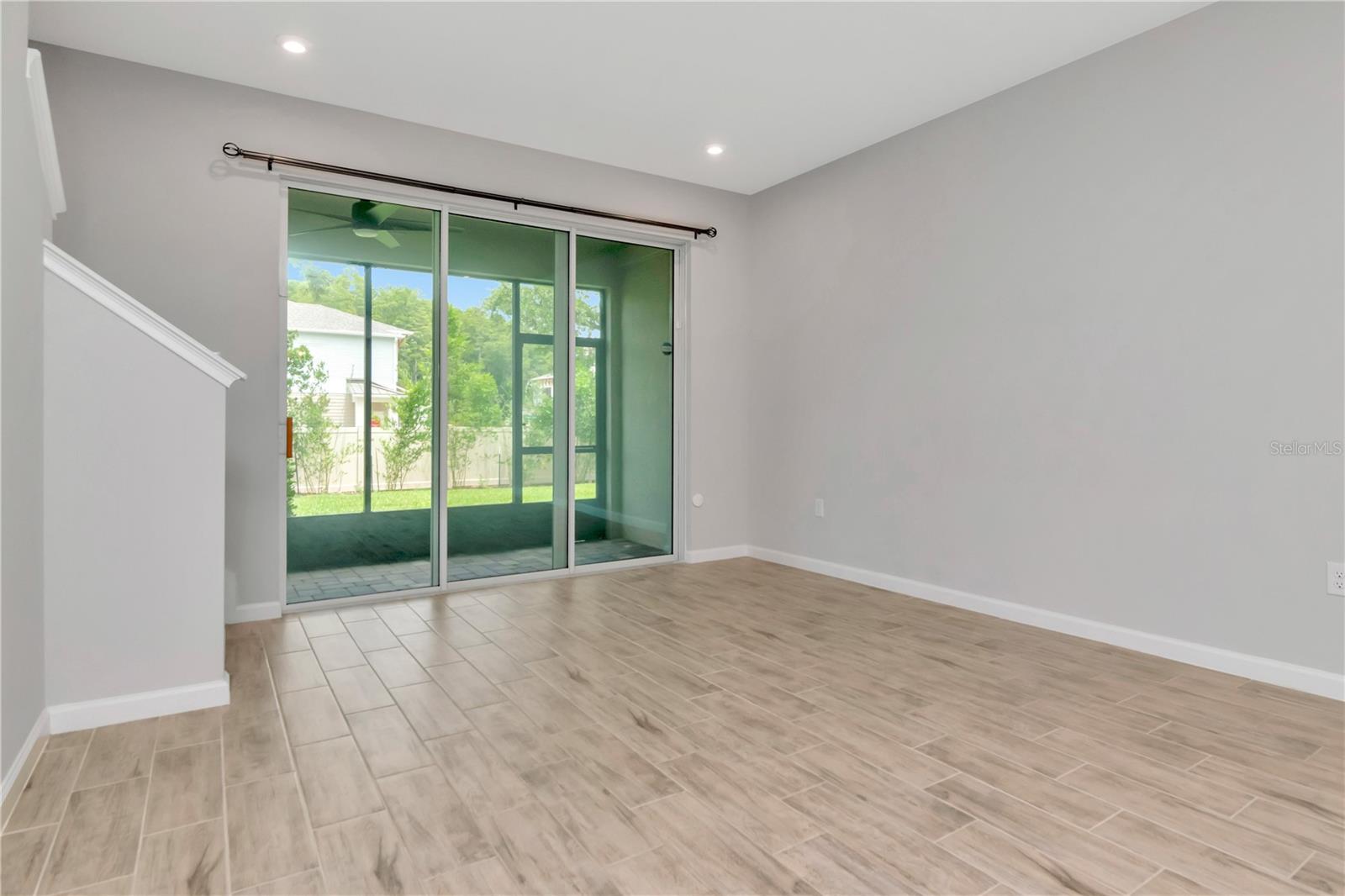 Living Room with Triple Sliders to Patio
