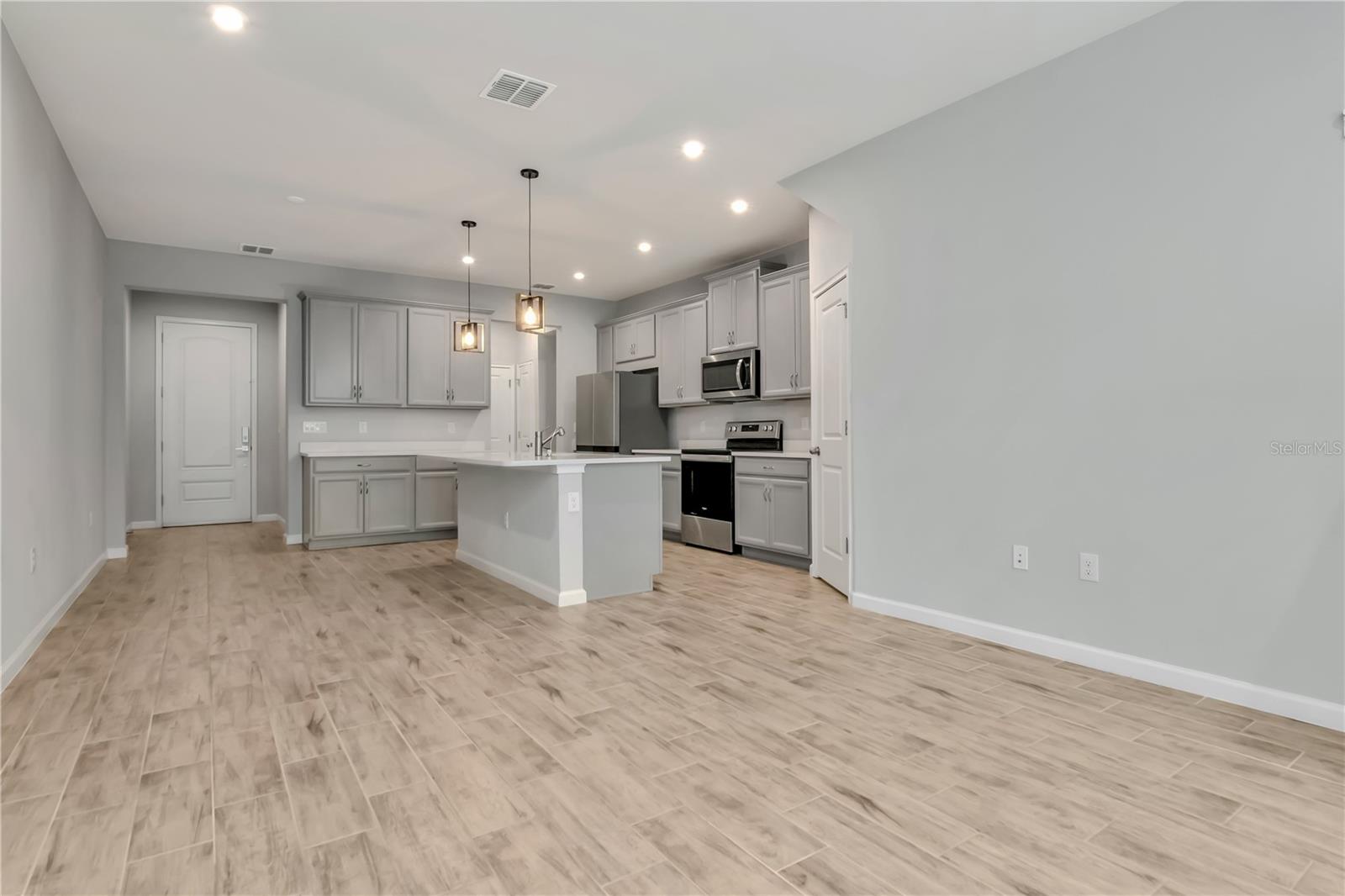 Living Room with Triple Sliders to Patio
