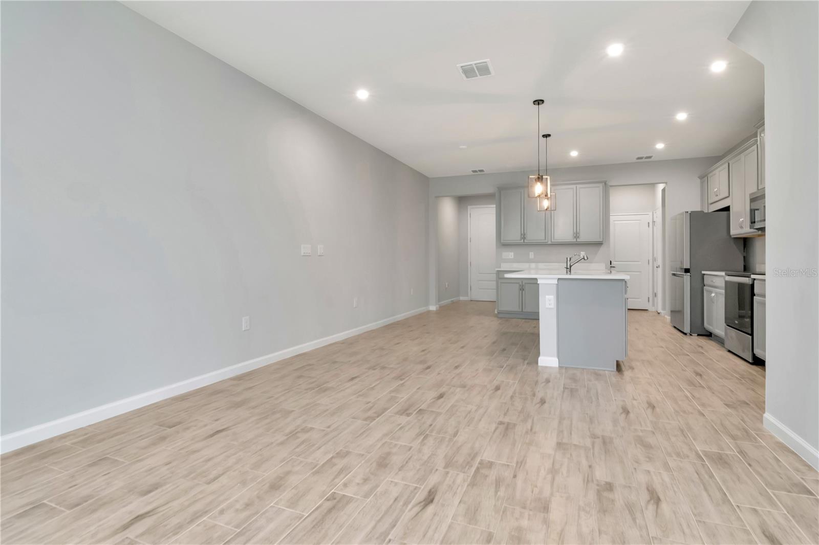 Living Room with Triple Sliders to Patio