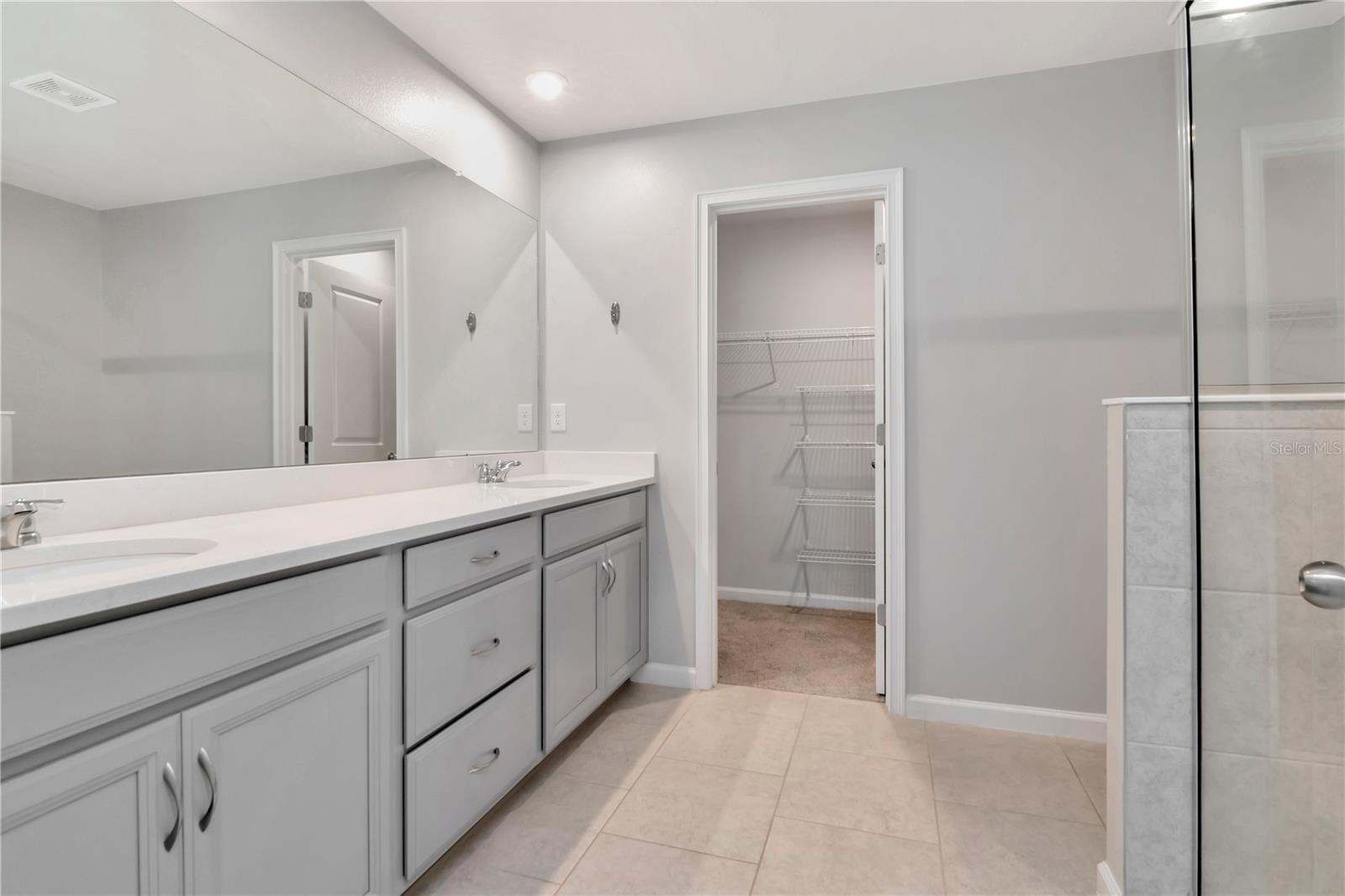 Primary Bathroom with Dual Vanities, Additional Walk In Closet, Walk In Shower