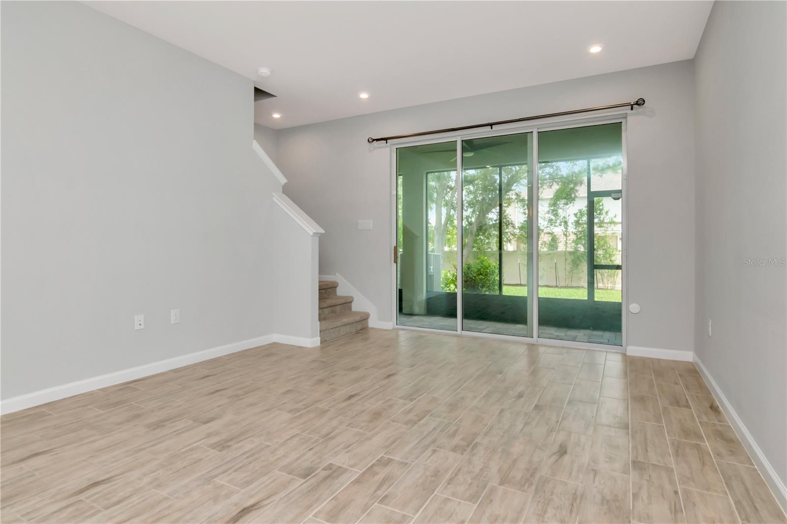 Living Room with Triple Sliders to Patio