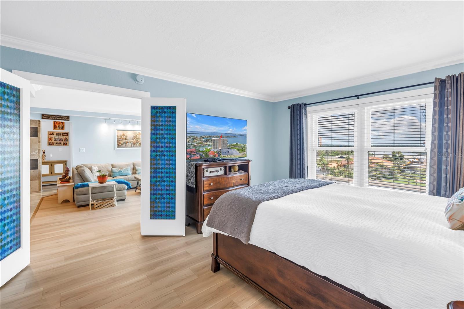 Primary bedroom with french doors (stained glass treatment is removable)