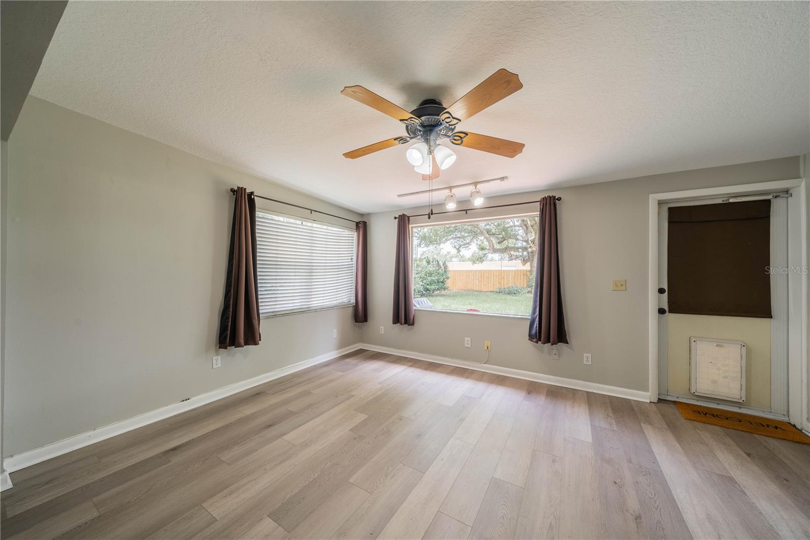 Florida room with picture window looking out to back yard. There’s even a doggie door.