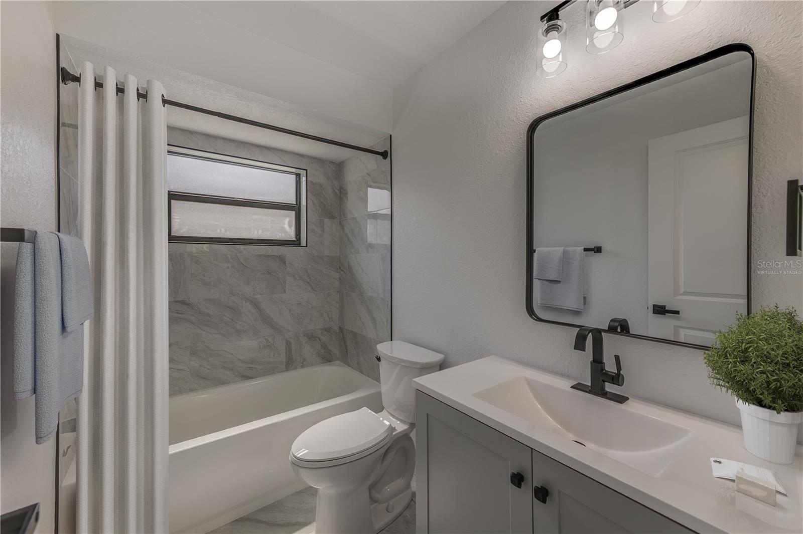 Virtually staged decor- Guest bath with bathtub