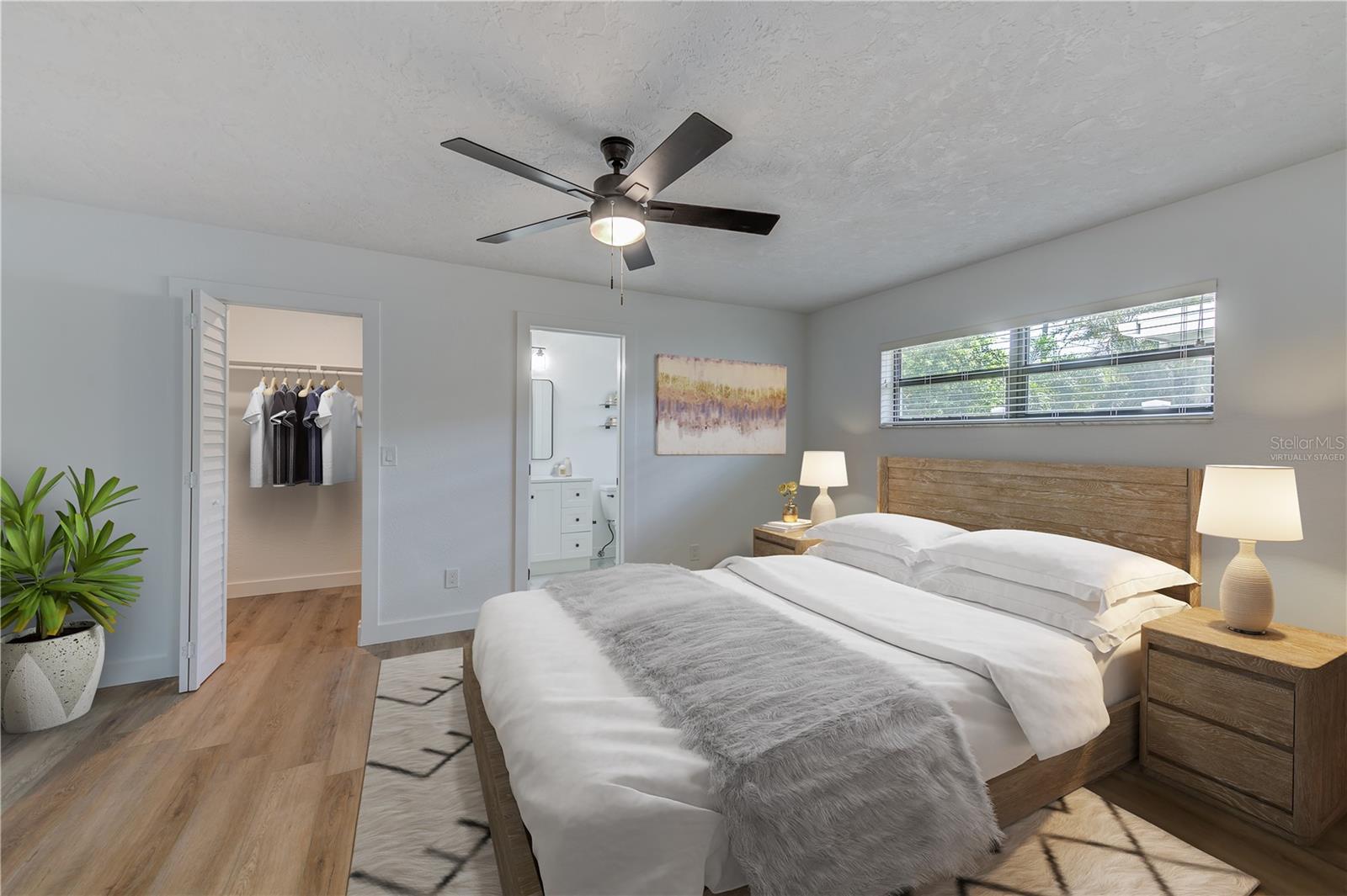 Virtually staged-Primary bedroom with ensuite and walk in closet. Fully remodeled bathroom with stand up shower.
