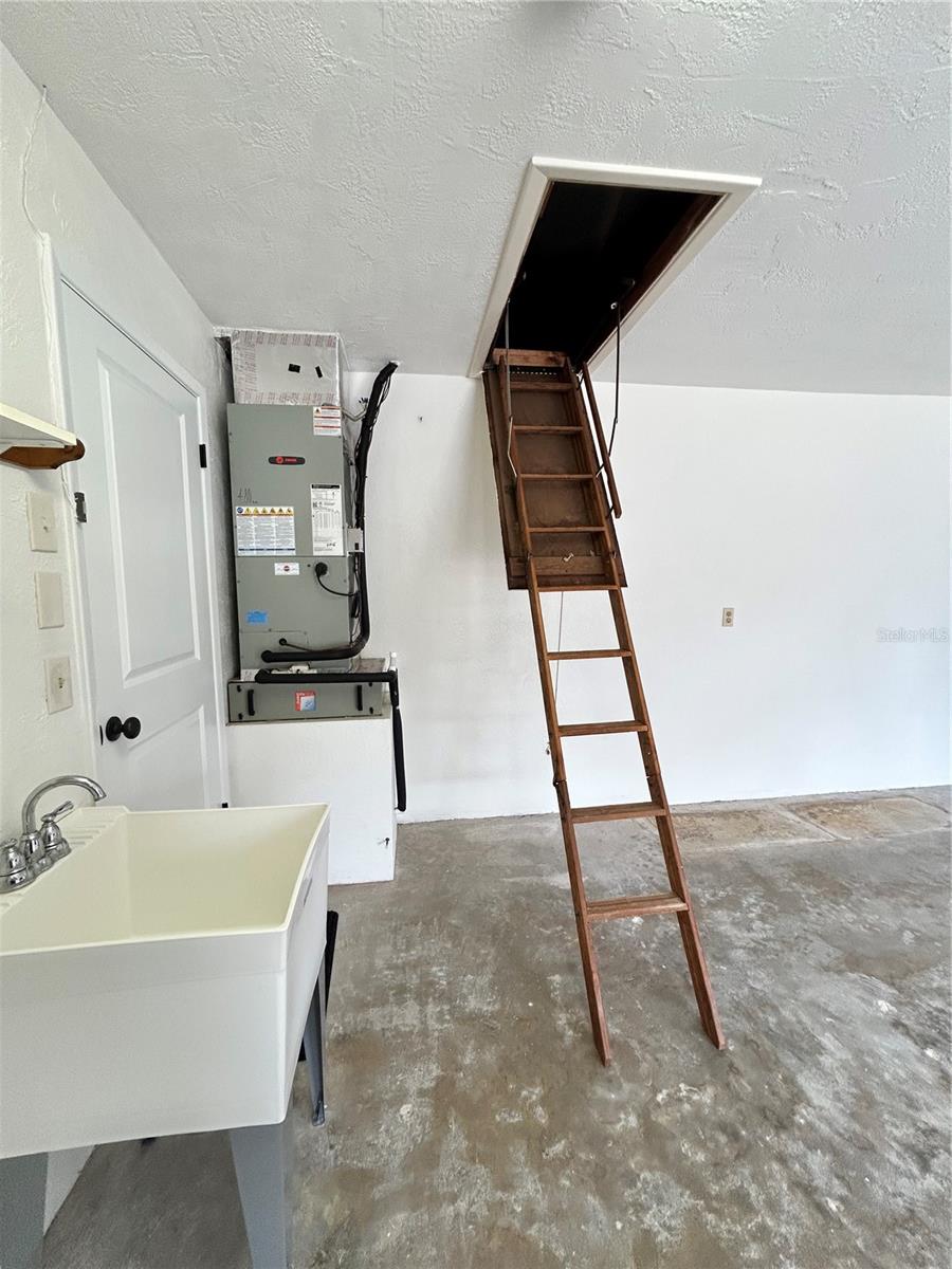 Attic access with ladder. There is quite a bit of room in attic to store items!