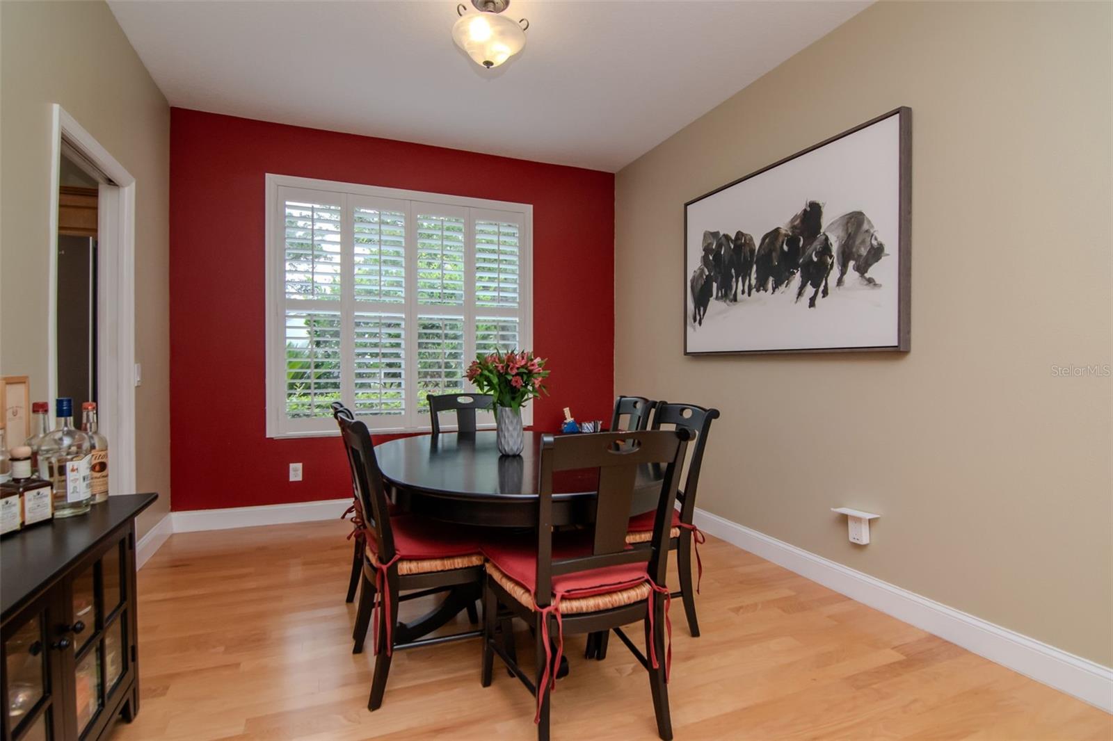 Dining Room off the kitchen featuring picturesque window and hard wood floors