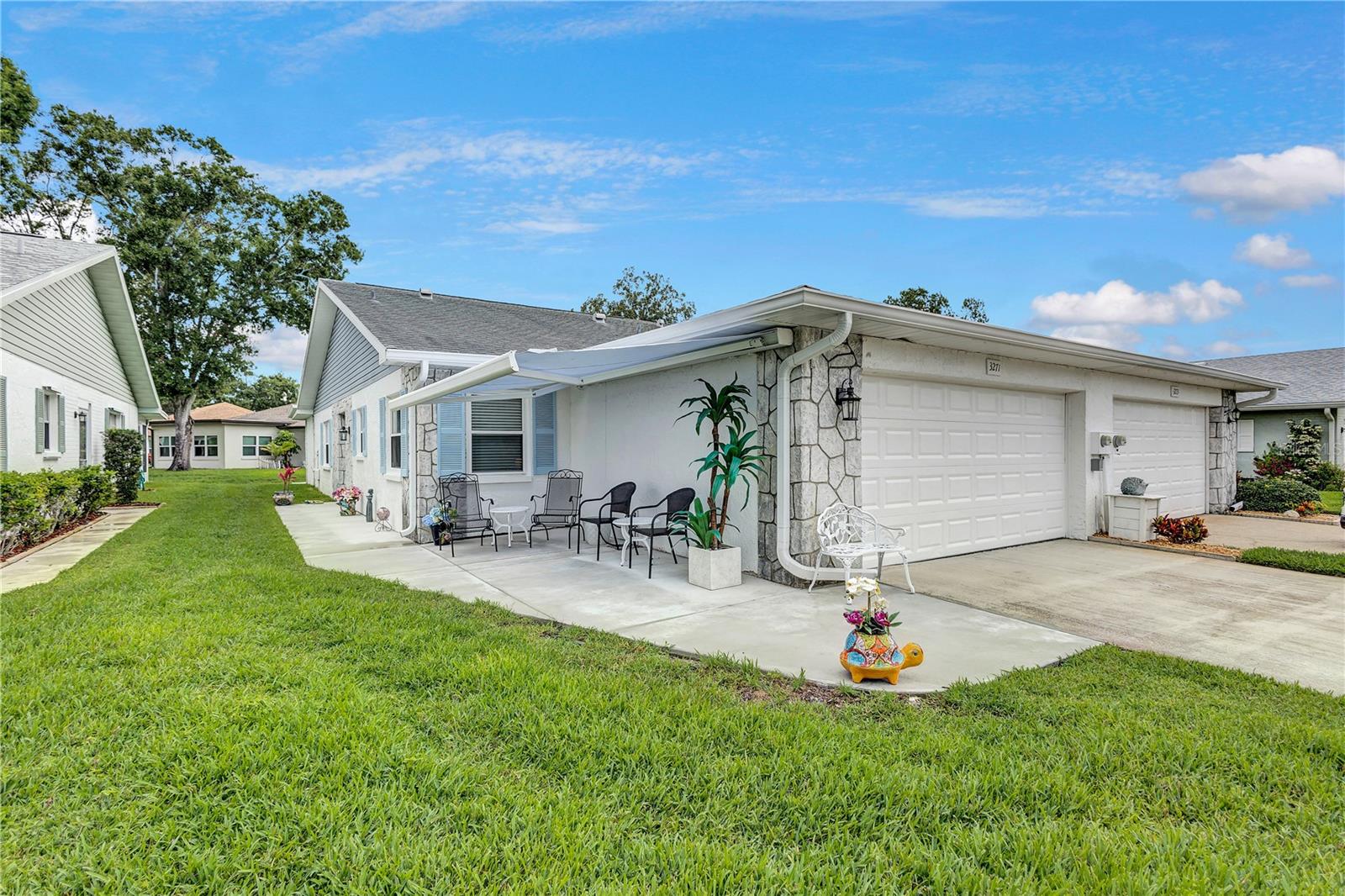 Two car garageand patio with retractable awning