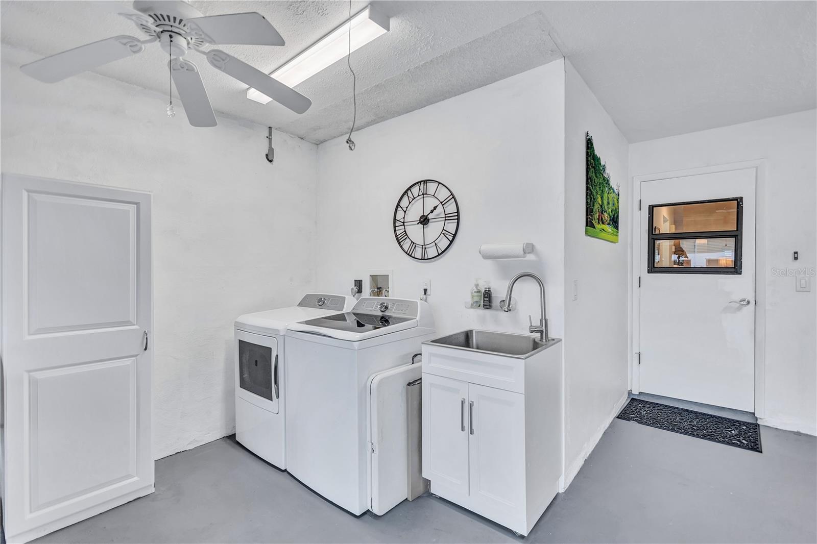 New washer and dryer with plenty of storage space in garage