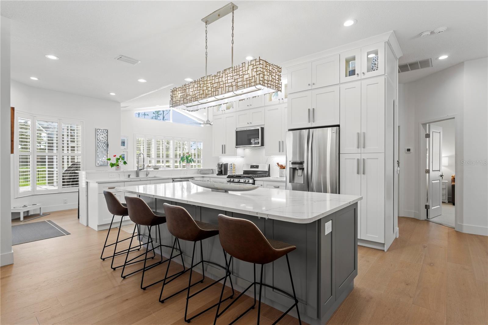 Beautiful granite countertops and cabinets that extend to the ceiling offer a custom look and an abundance of storage to keep everything neatly tucked away.
