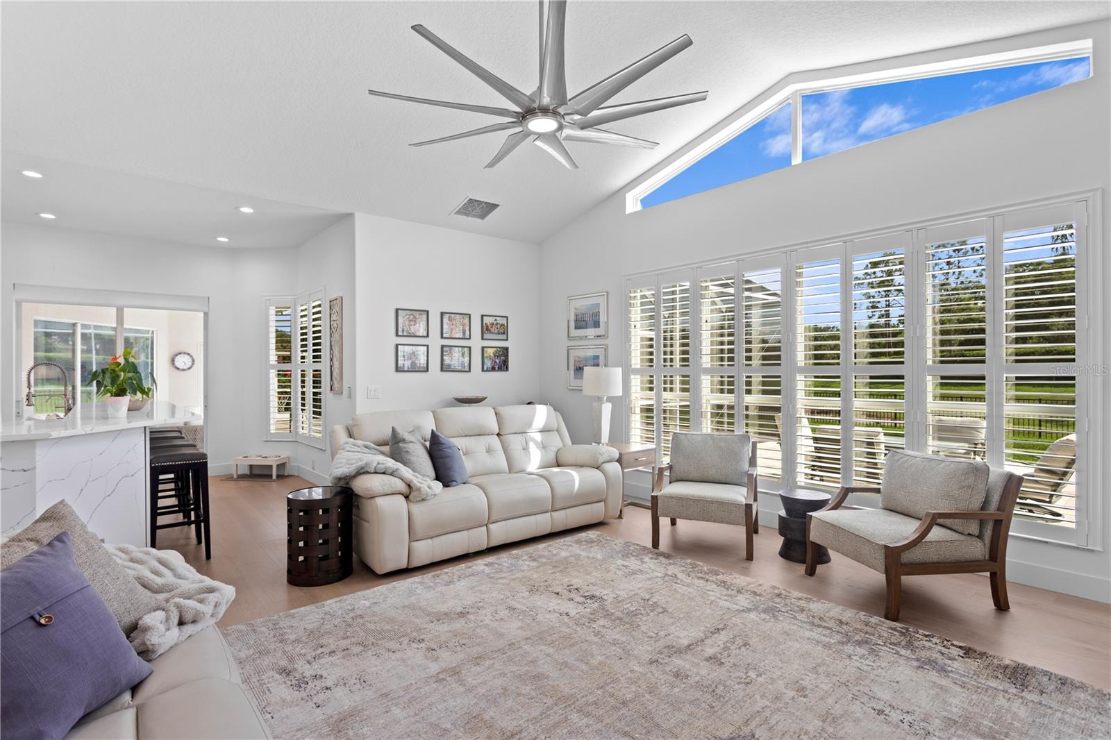 This spacious family room offers a relaxed setting with lots of natural light and a view of the serene backyard.