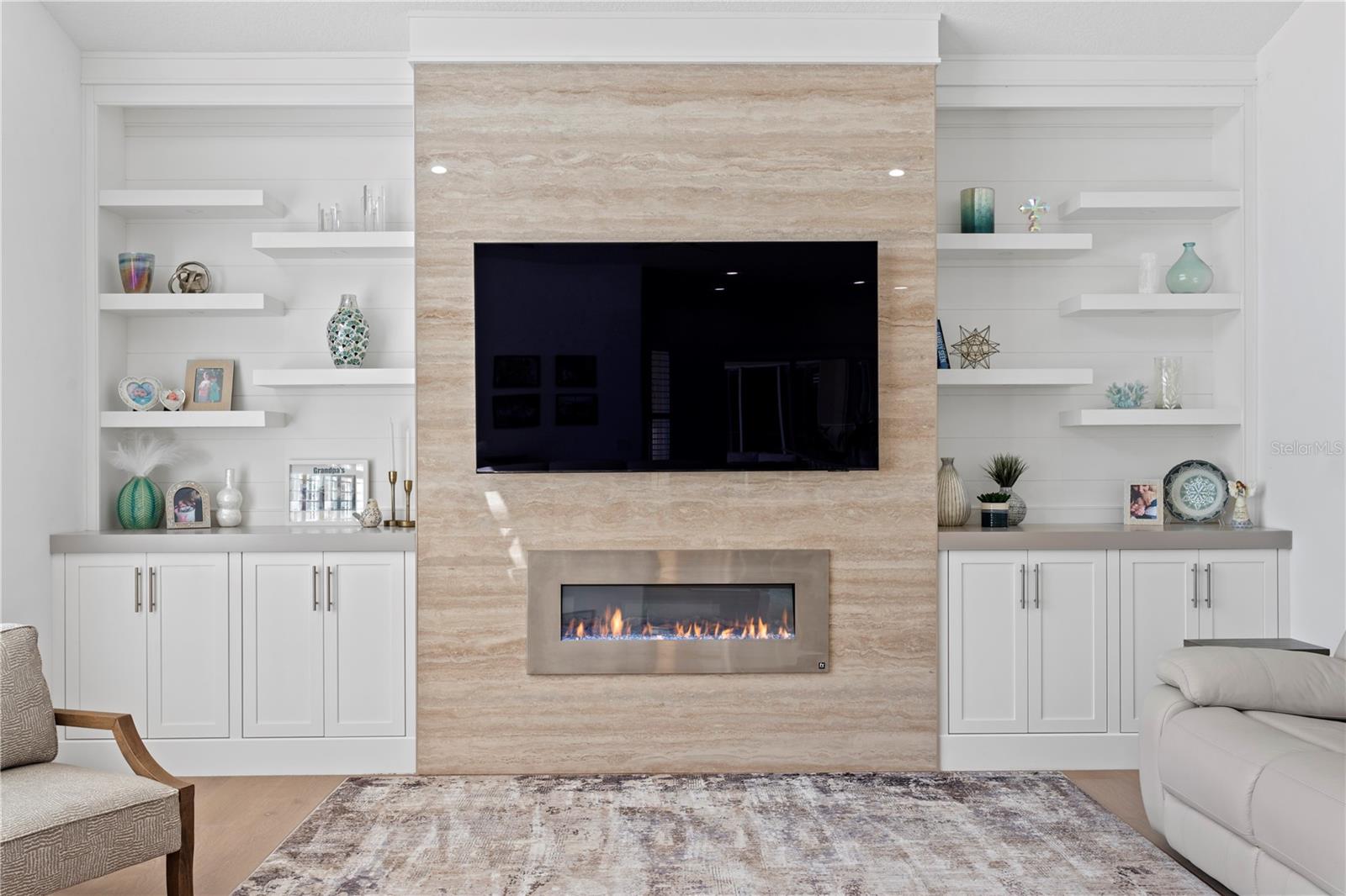 A stunning focal point of the family room - custom built-ins and decorative fireplace - blend style and function to this space.