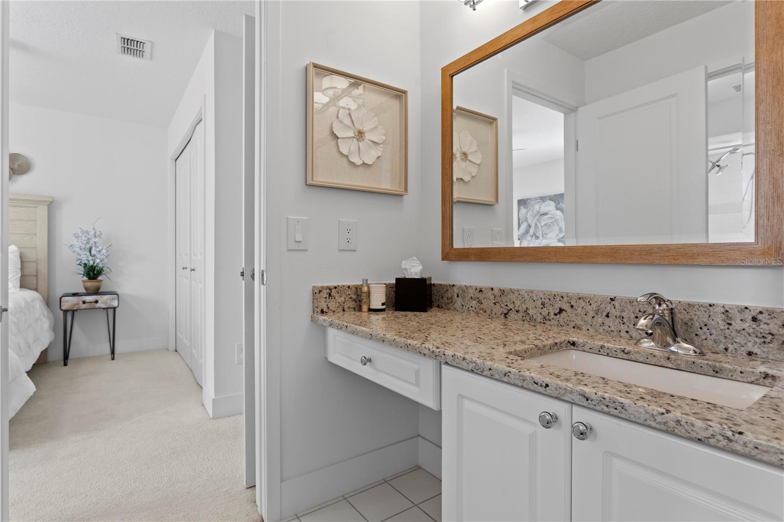 A well-designed Jack and Jill bathroom connects two generously sized bedrooms, featuring dual sinks - one in the main bath area with the shower and toilet, and another just outside for added convenience.
