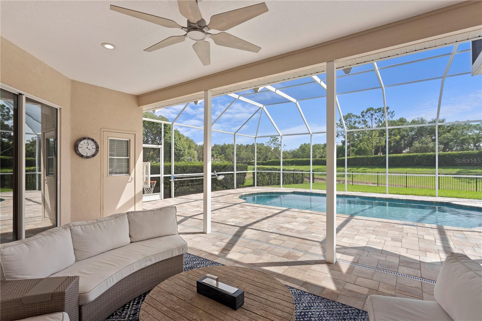 This beautifully paved lanai offers the perfect space to relax or entertain with a covered area ideal for lounge seating or an outdoor dining table.