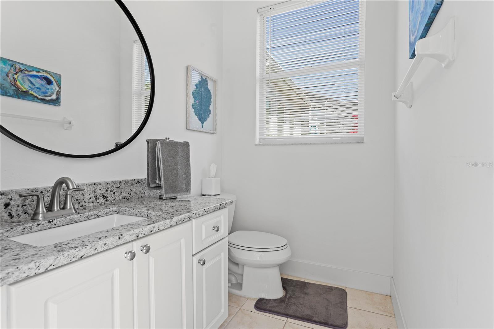 This perfectly placed half bath is accessible from the lanai and pool area.