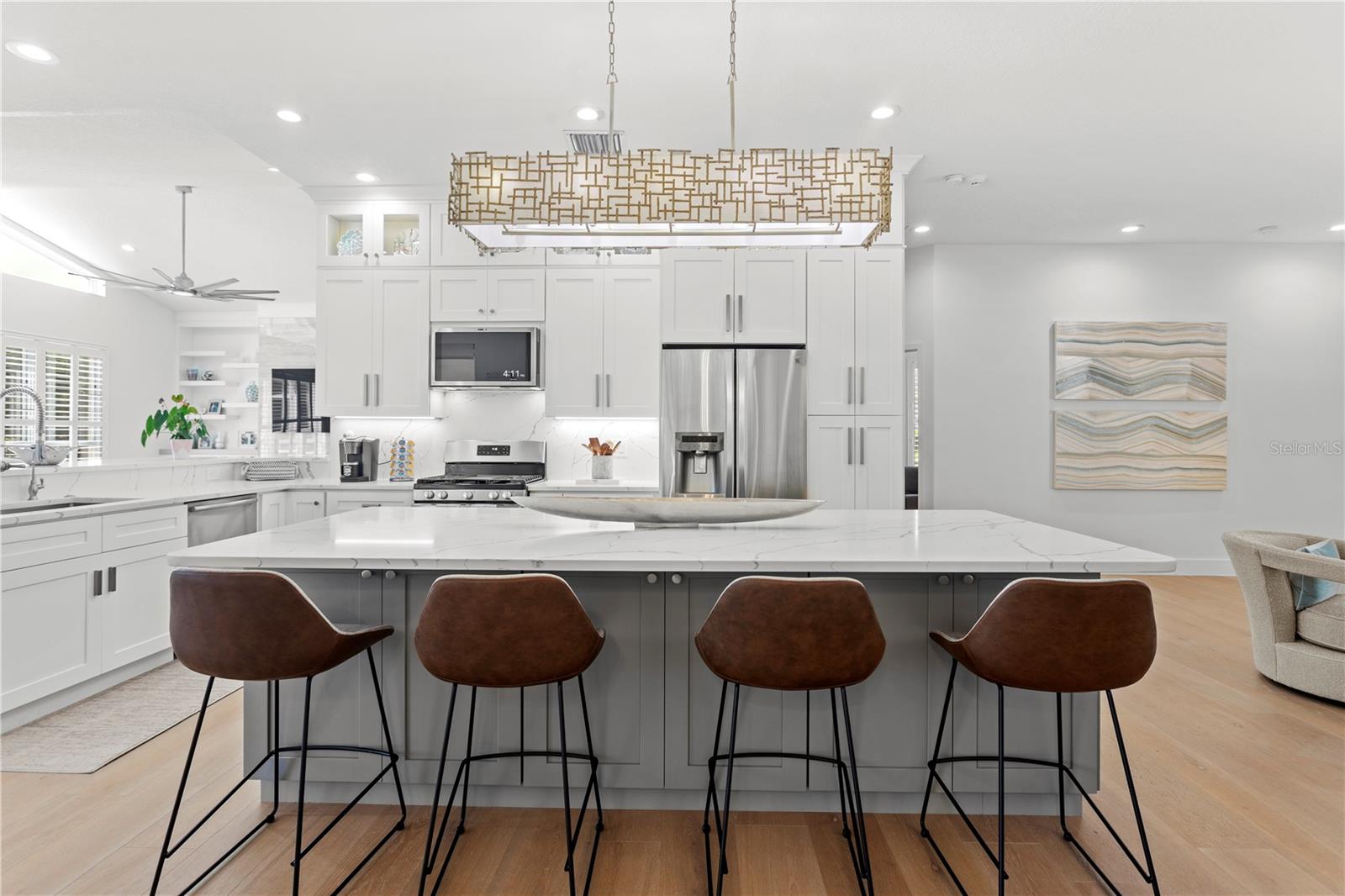This stunning kitchen is the heart of the home, featuring an oversized island perfect for gathering, prep, and entertaining.