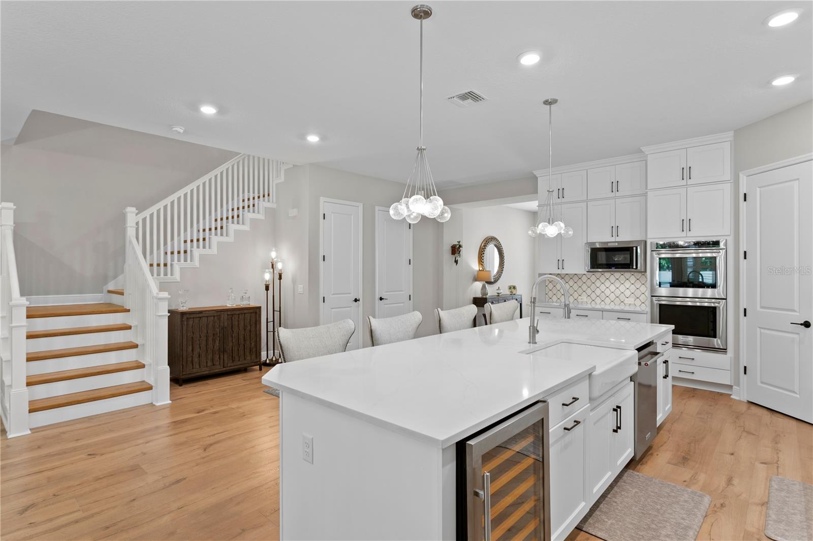 The large kitchen island features a convenient wine refrigerator.