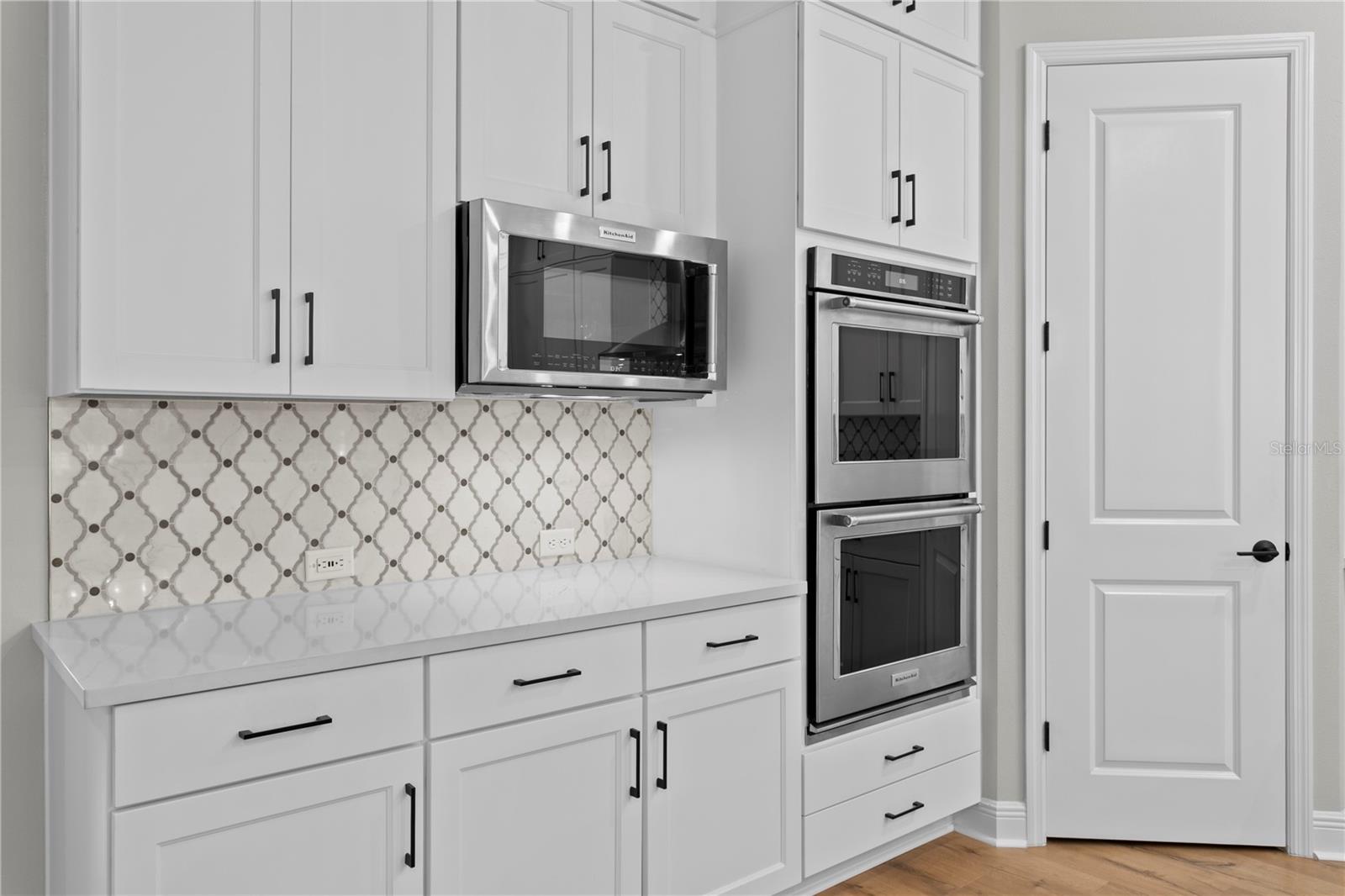 Style meets storage in this kitchen, with beautiful tilework and a walk-in pantry right where you need it.