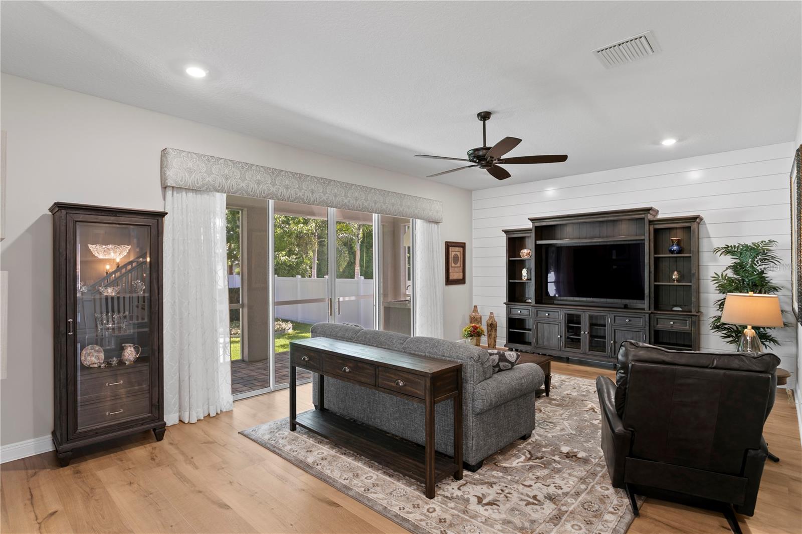 Cozy up in this spacious family room with shiplap charm and seamless indoor-outdoor living.