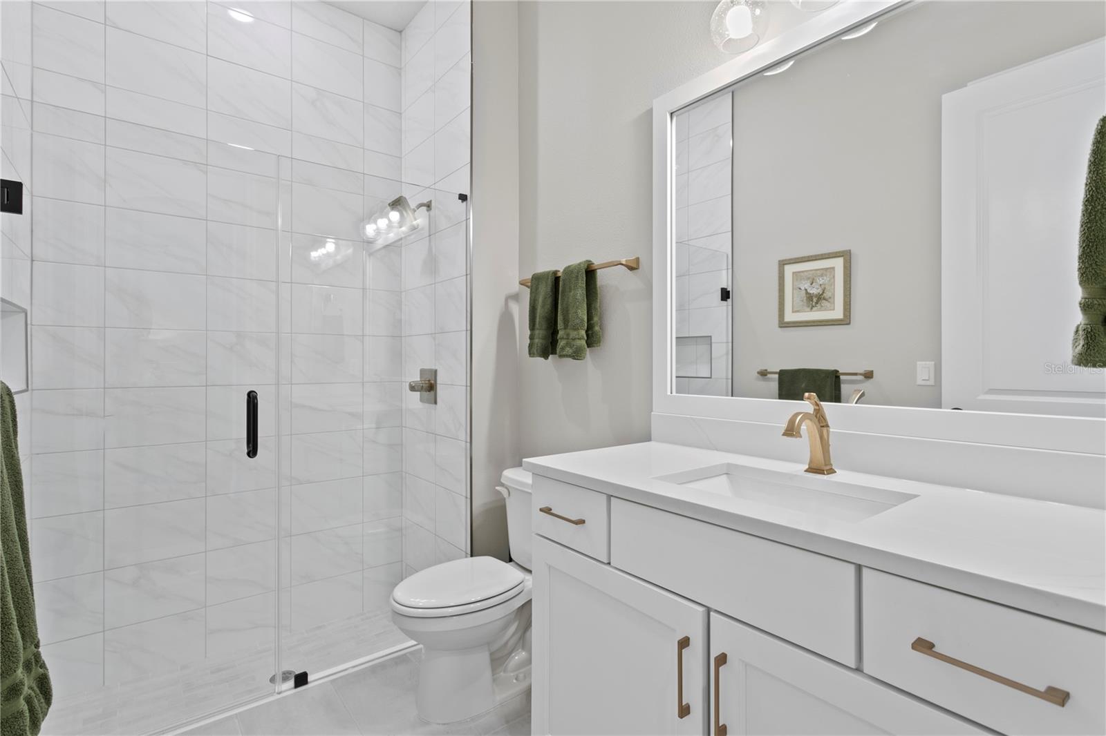 The downstairs full bathroom is tastefully designed as is the rest of the home.