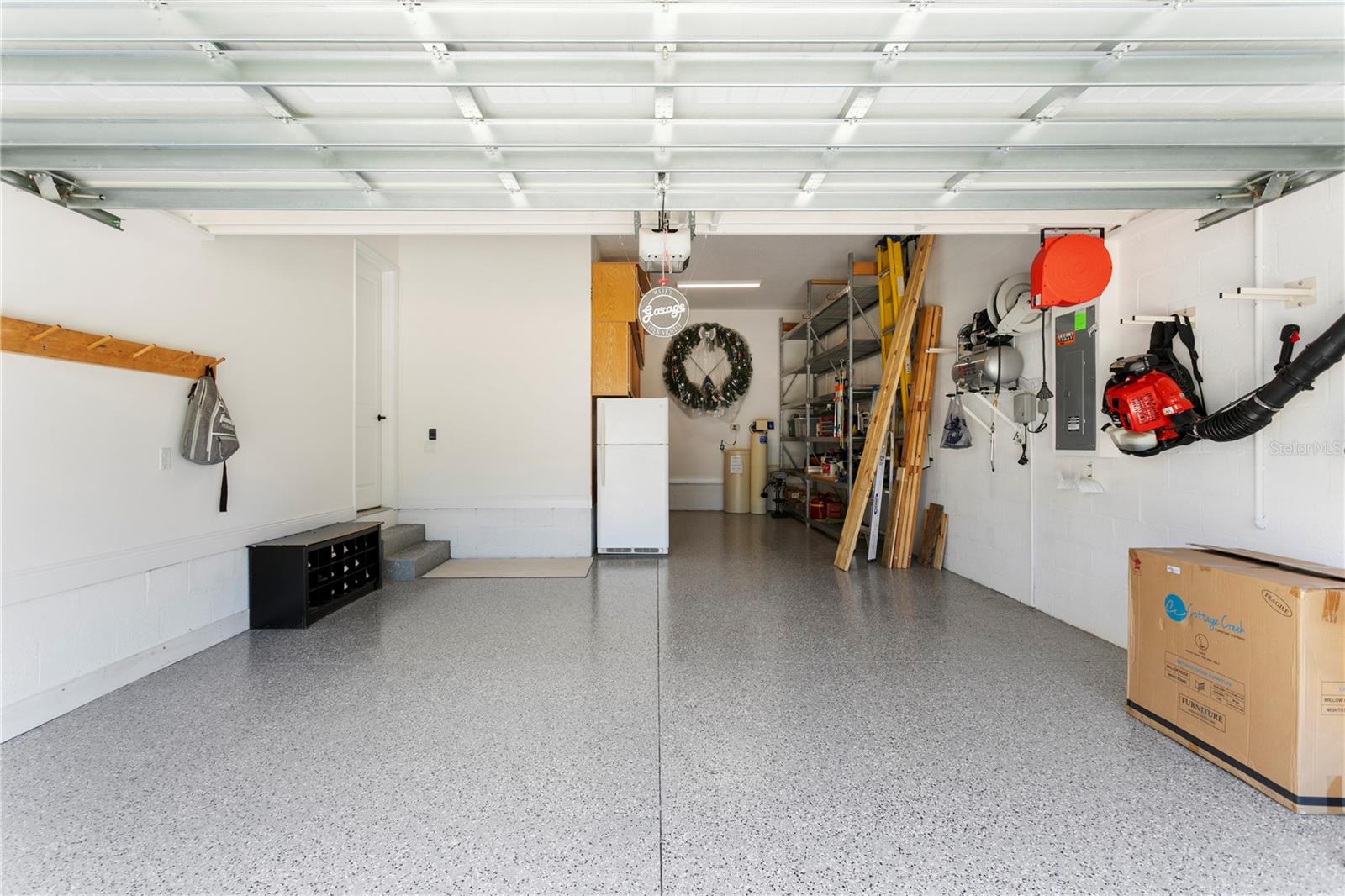 This is a dream garage, with epoxy flooring, and room for 3 cars (two tandem).