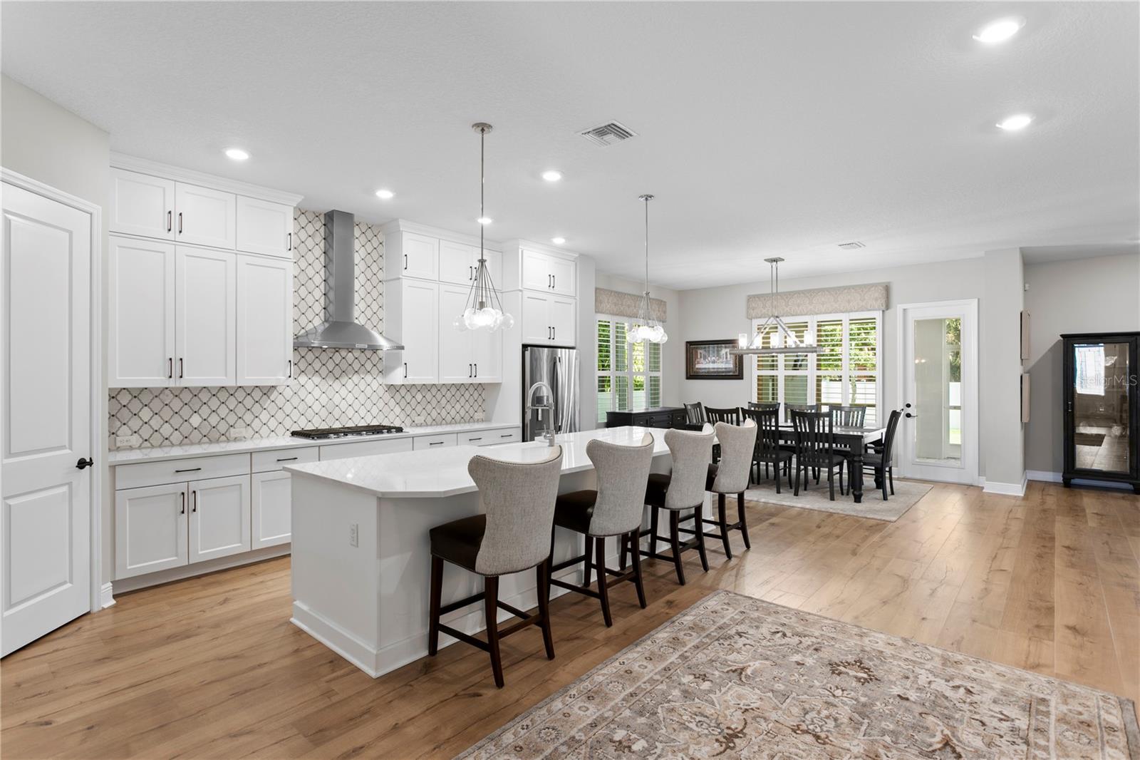 The gorgeous chef's kitchen features a gas cooktop and double ovens.