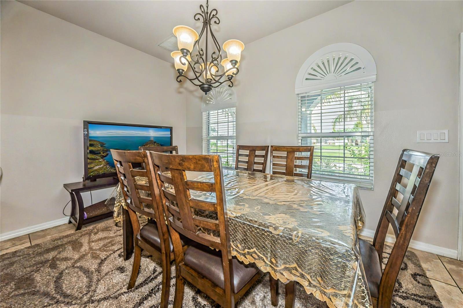 Formal dining area with chandelier and tile flooring
