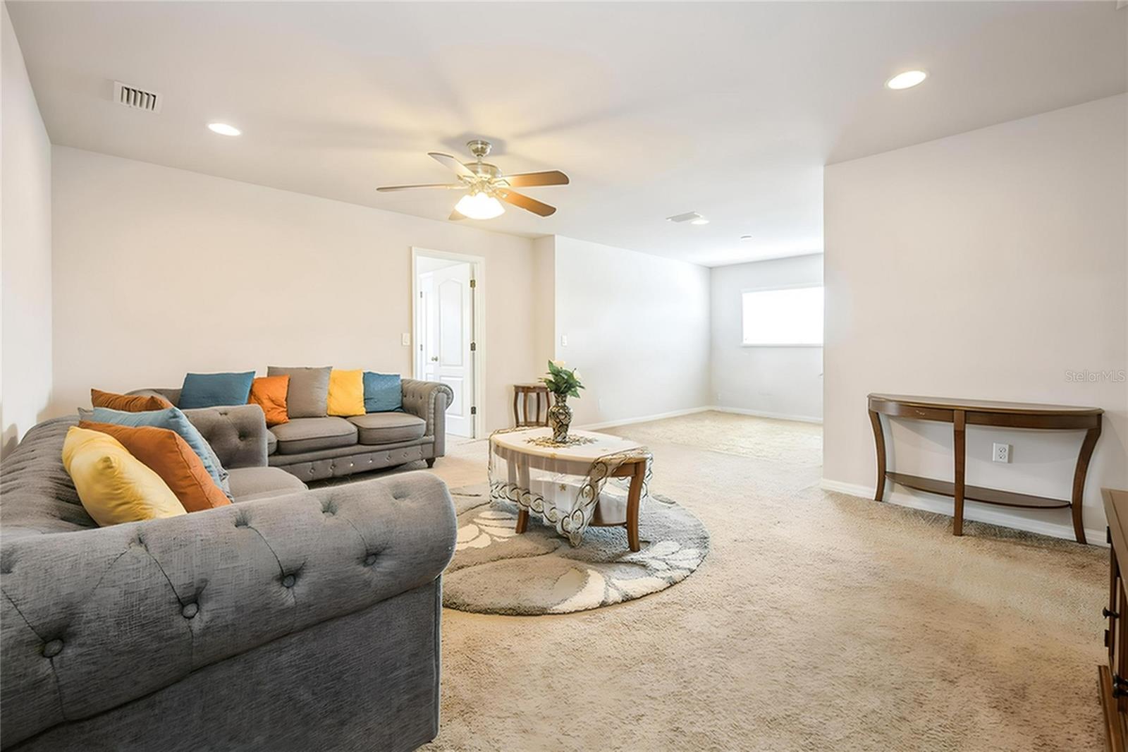 Spacious upstairs loft perfect for a second living area, media space, or playroom.
