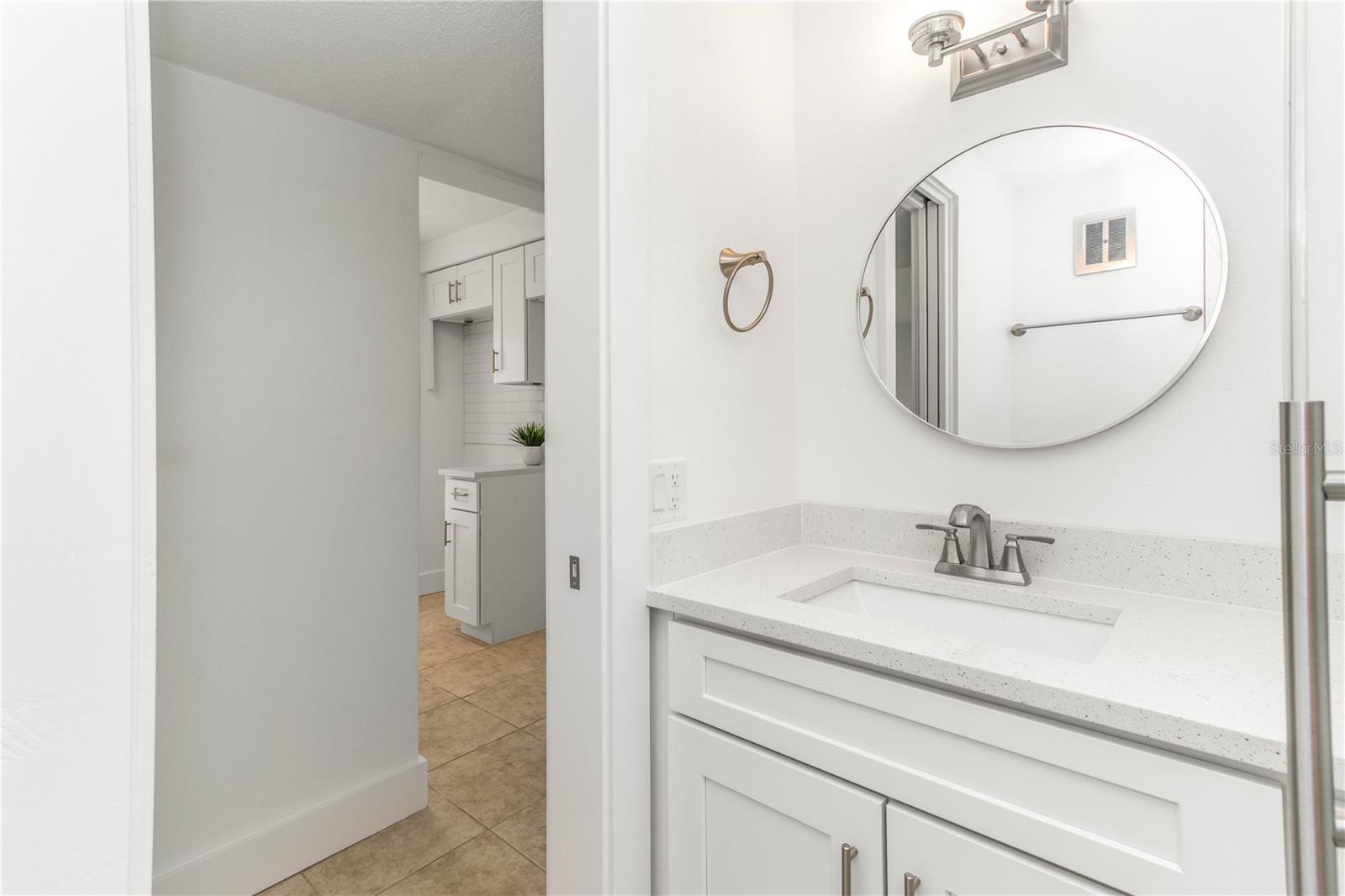 GUEST BATHROOM WITH HALLWAY BETWEEN THAT AND KITCHEN