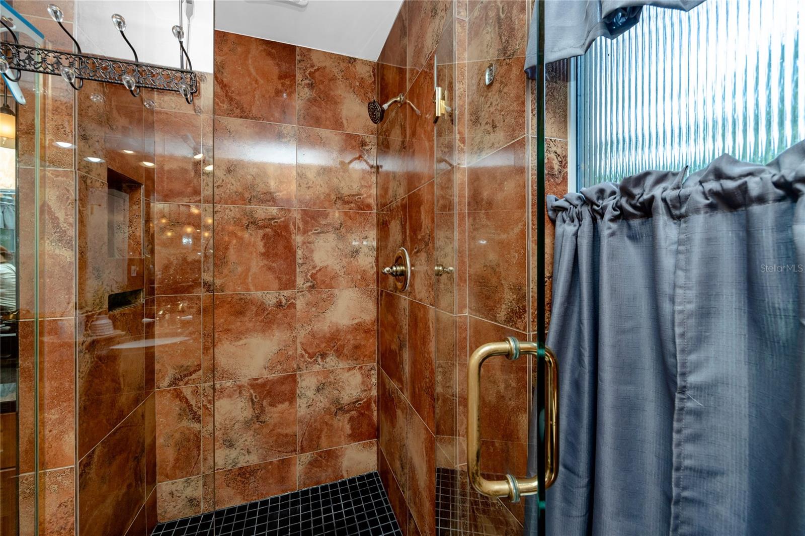 Walk in shower with glass doors.