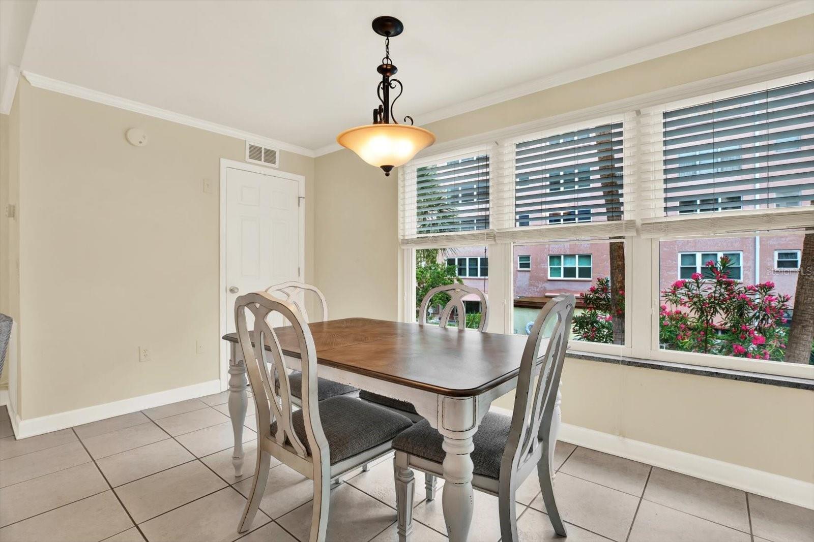Dining area overlooking the sparkling pool