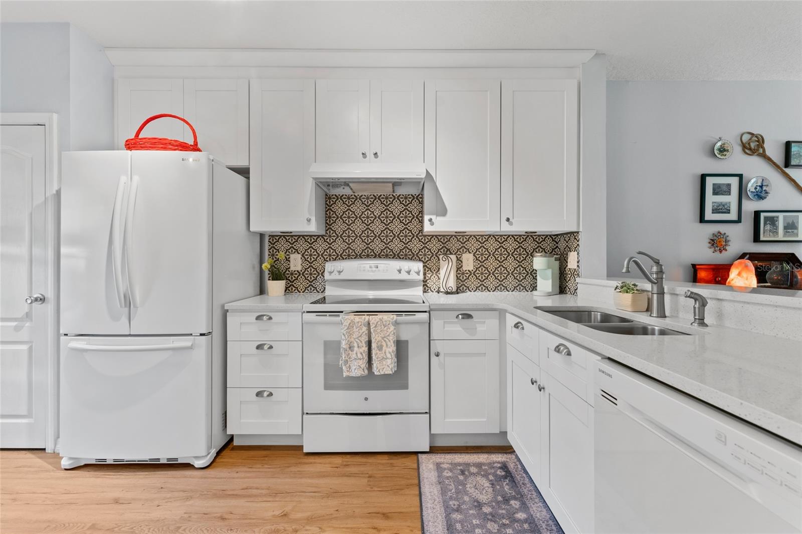 Remodeled kitchen-quartz counters, undermount sink, backsplash, 42" uppers, French door refrigerator, & closet pantry