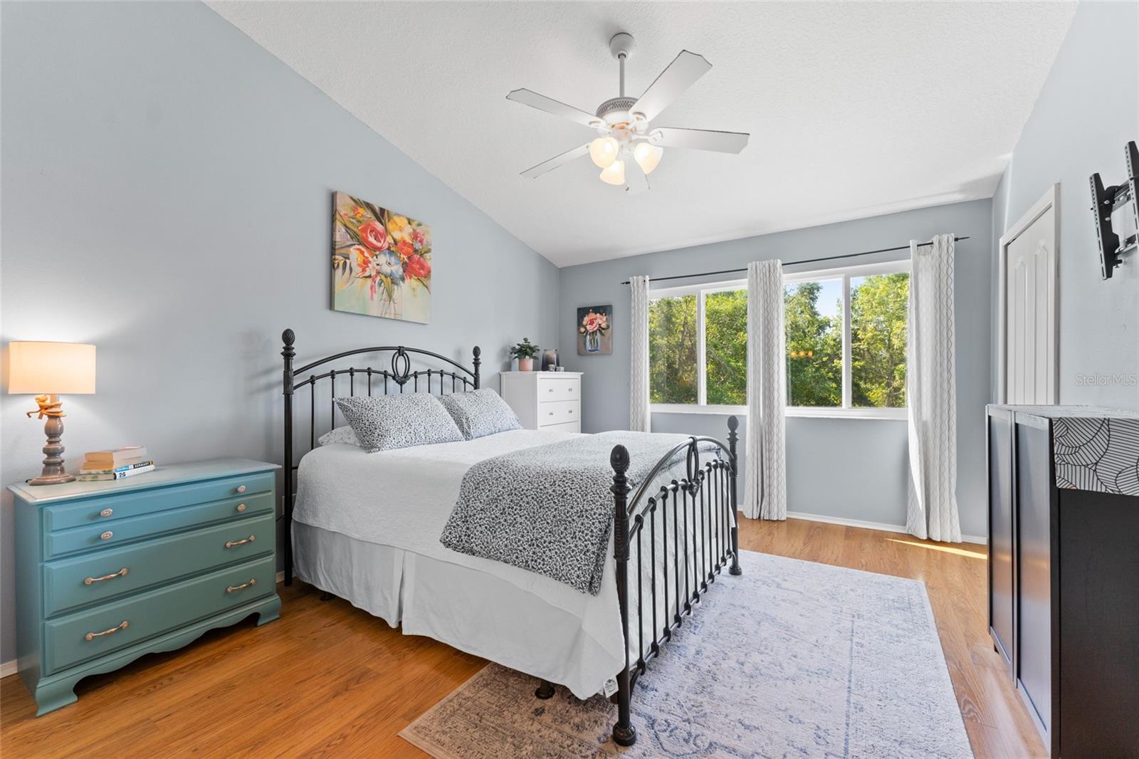 Primary bedroom-vaulted ceiling with fan, LV flooring, Energy Star sliding windows not only save $$ but give an unobstructed view.