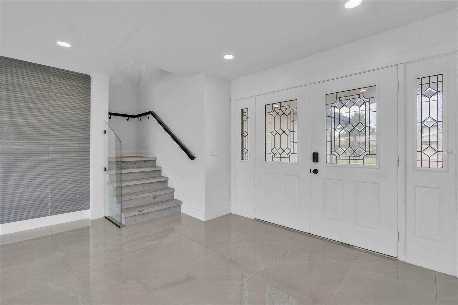 Beautiful entry doors and stairwell leading to the 2nd floor.