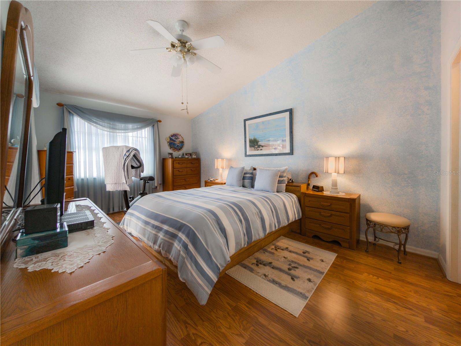 Primary bedroom with vaulted ceilings