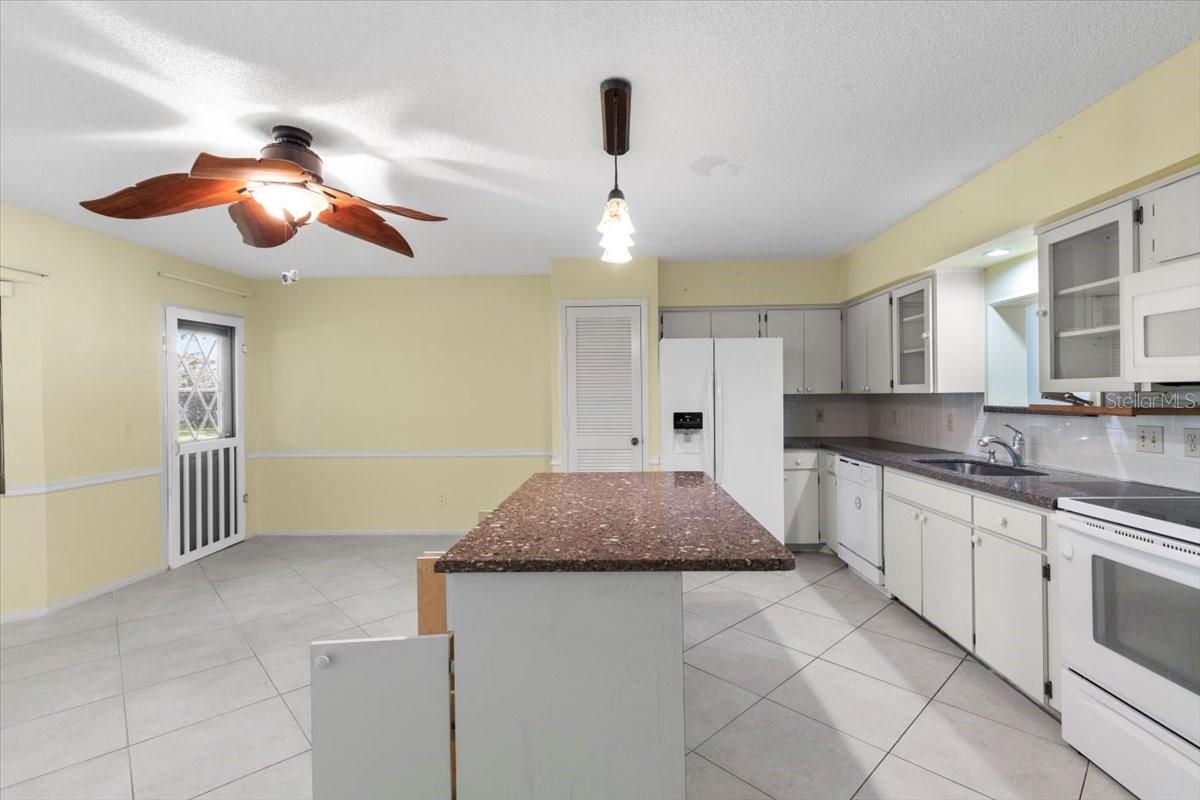 View from laundry into kitchen and back family room combo