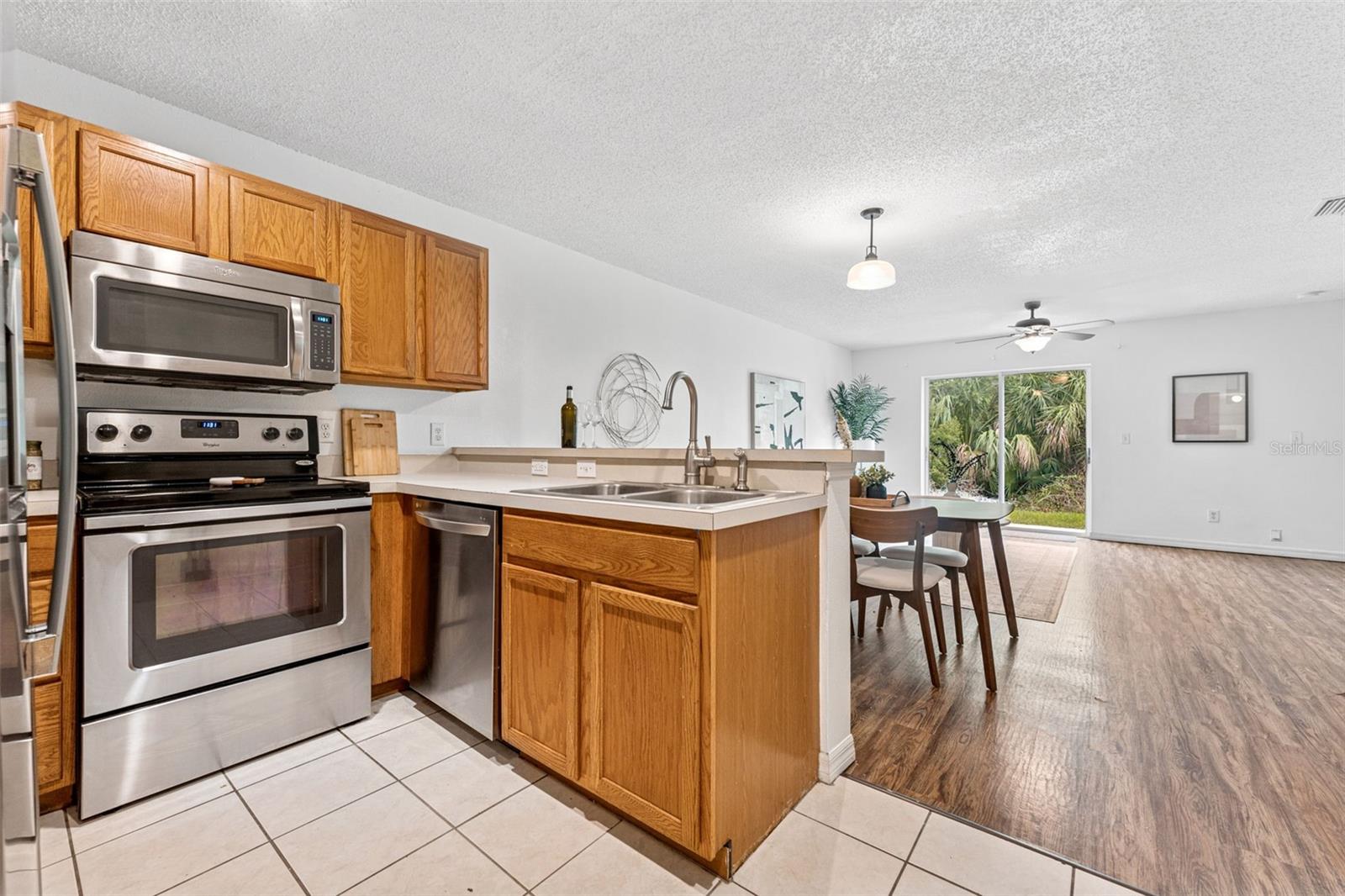 Stainless steel appliances and a view of the tropical conservation to make cooking a delight