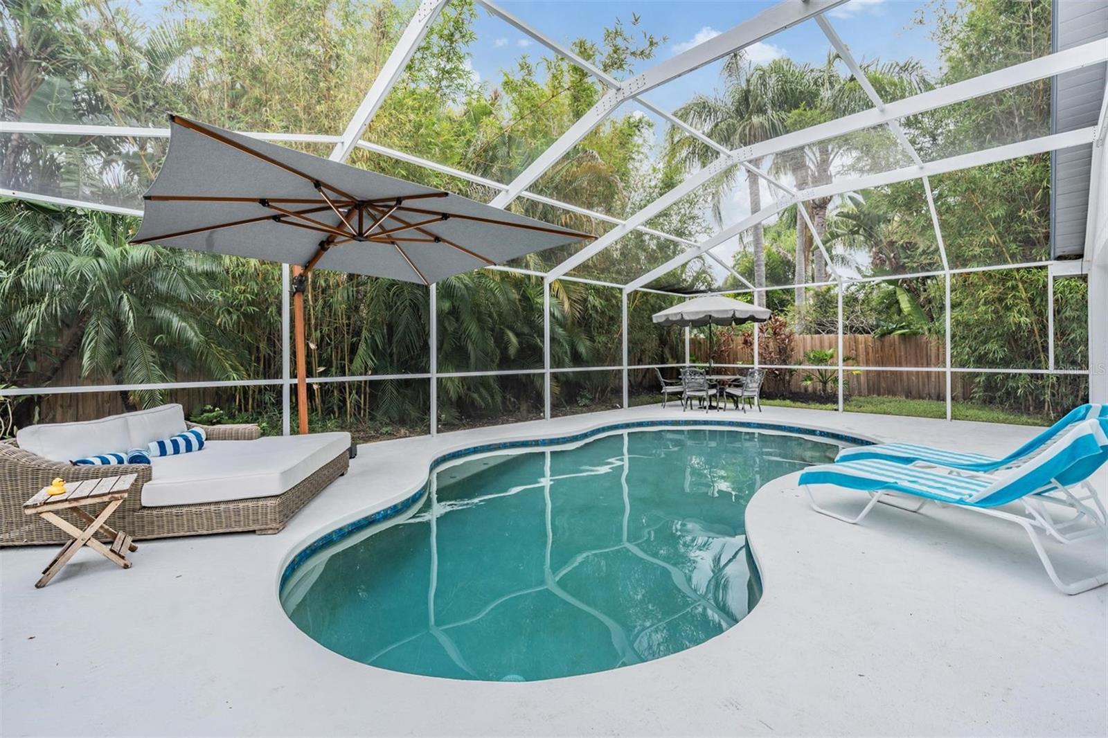 Huge Screened In Pool Deck with Lush Landscaping