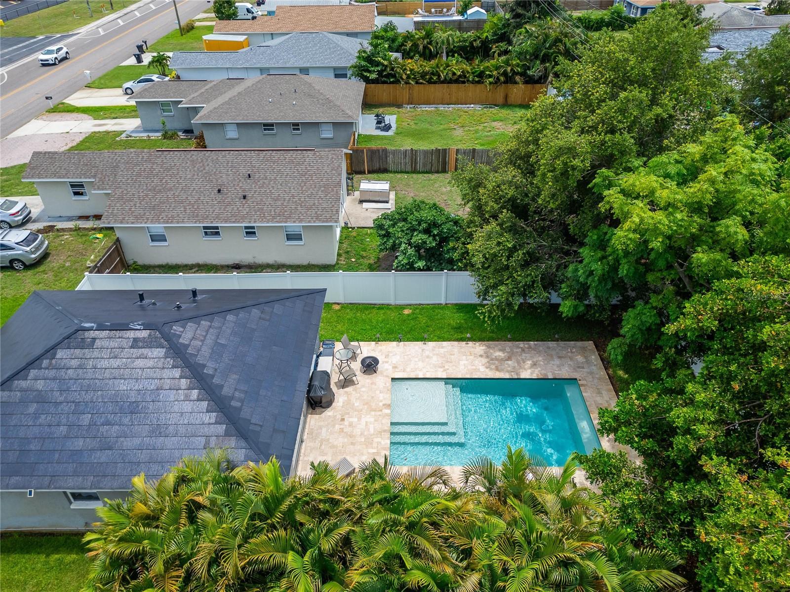 Surrounded by lush, professionally landscaped greenery and mature swaying palm trees