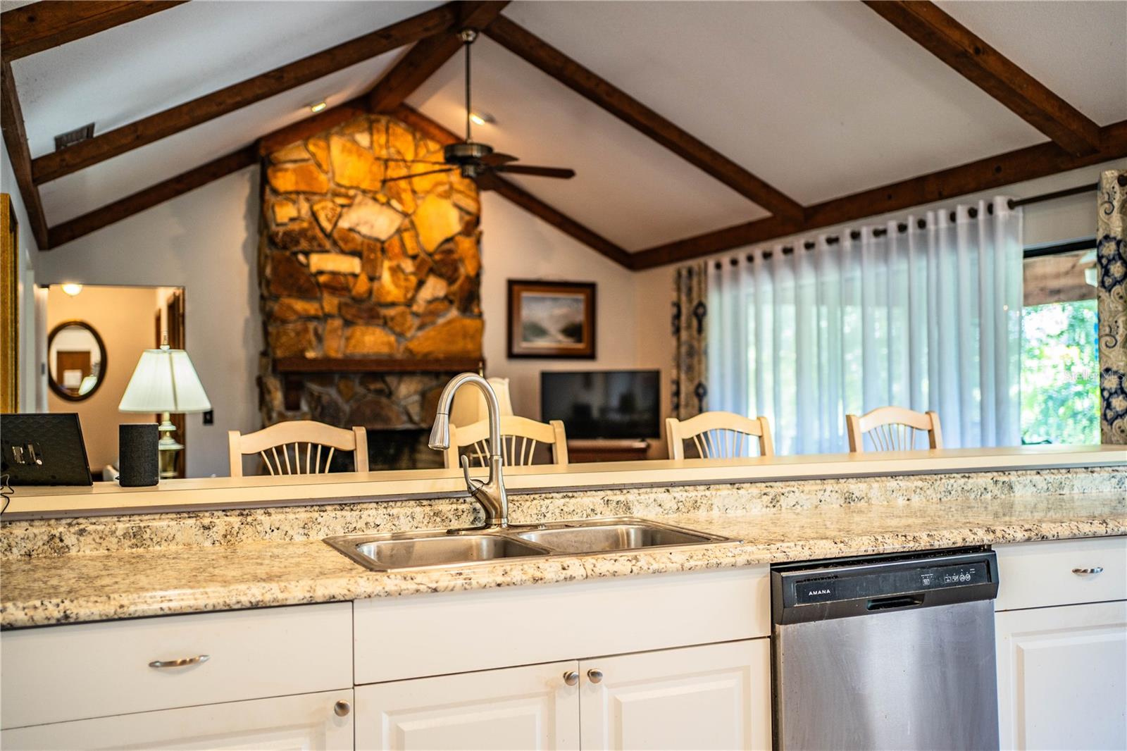 Charming fireplace and rich wood details create a cozy, inviting living space.